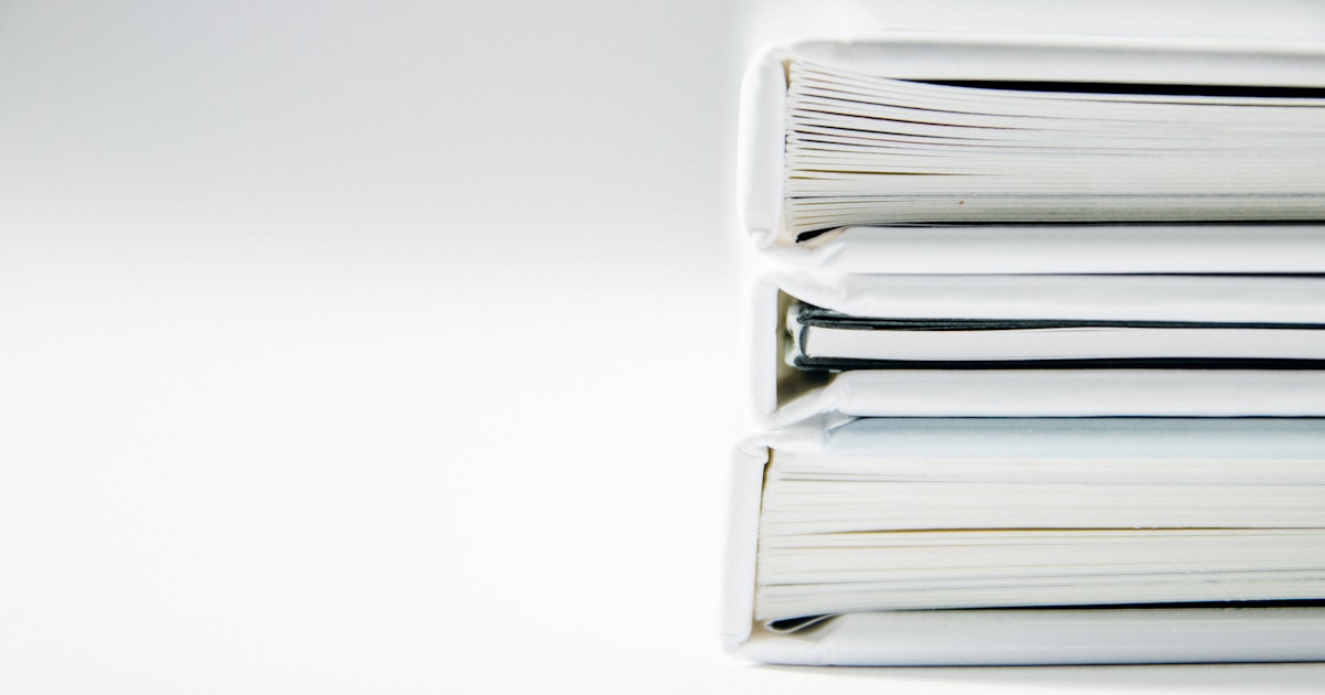 A stack of thick document folders, standing in for one incident filed once each in Korean, Japanese, Chinese, and English